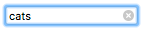 Focused search input, with focus ring, with the text 'cats'. There is an x icon in the input abutting the right side.